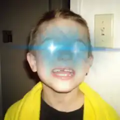 Boy with glowing blue eyes