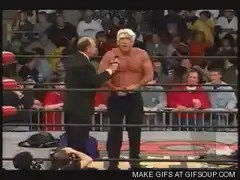 Wrestler climbs out of ring onto announce table