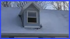 Snowy roof with dormer window