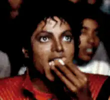 Michael Jackson eating popcorn and smiling