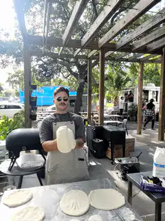 Man tossing pizza dough