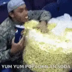Man eating popcorn and soda
