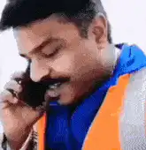Man on phone shushing camera