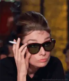 Audrey Hepburn smoking and looking up