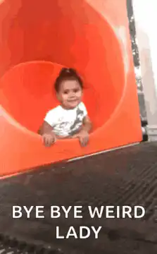 Baby slides down orange tube