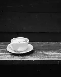 black and white coffee cup on wooden table