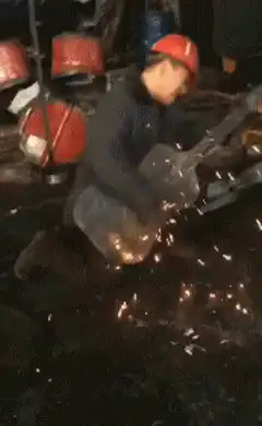 Worker plays guitar with angle grinder