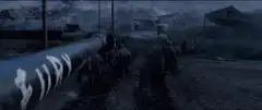 Soviet soldiers walking past a large pipe