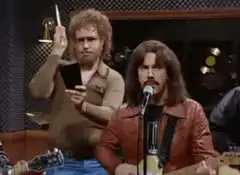 Randy Newman singing with a man counting behind him