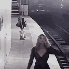 Woman waves at train on platform