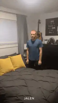 man falls backward onto bed