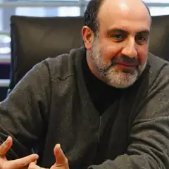 Man with beard smiling and gesturing