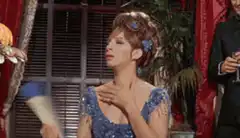 Woman fanning herself with a blue fan