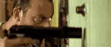 Jean Reno aiming gun