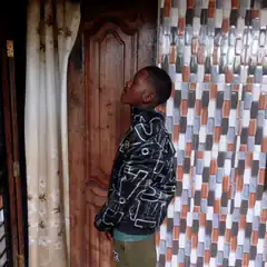 Man leaning back against wooden door