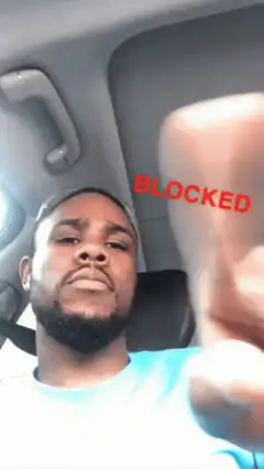 Man in car with blocked hand