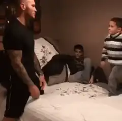 Man gets tackled by kid on bed