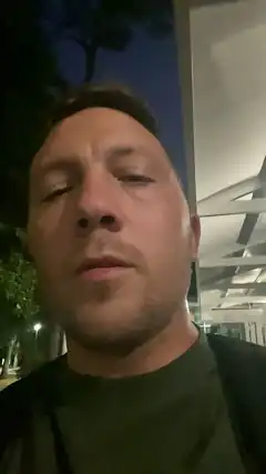 man with eyes closed at night
