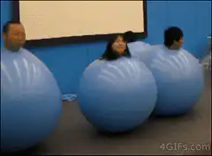 People in giant blue inflatable balls