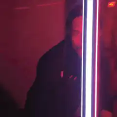 Man dancing behind light strip