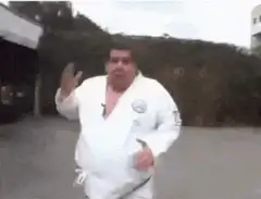 Fat man in white gi doing martial arts