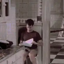 Man reading book sees ghost