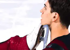 Figure skater holds skate to neck