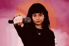Girl pointing microphone at camera