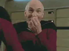Captain Picard smirking and laughing