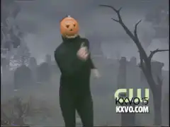 Pumpkin head dancing in graveyard
