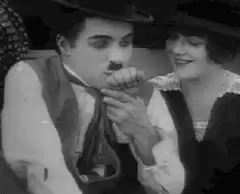 Charlie Chaplin eating a chicken leg