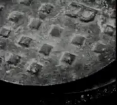 Manhole cover opens to reveal face