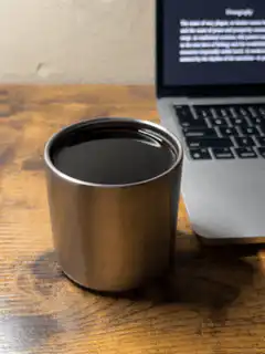 coffee cup next to laptop