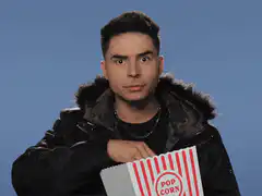 Man eating popcorn with wide eyes