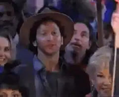 Man in hat pointing up
