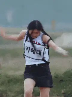 Two girls running in a race outdoors