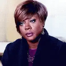 Viola Davis looks down and grabs her bag