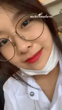 Girl in glasses smiles and winks