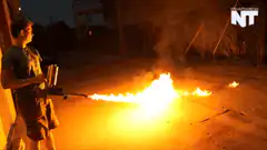 Man using a flamethrower at night