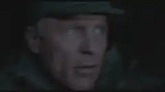 Old man looks through binoculars then shoots