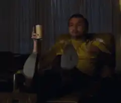 Guy in yellow shirt pointing at camera