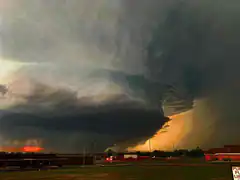 massive tornado over town at sunset