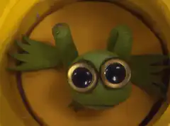 Green frog in yellow bucket