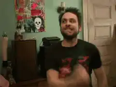 Charlie Day shrugging in a room