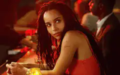 Zoe Kravitz winking at the bar