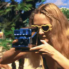 Woman with heart sunglasses takes photo