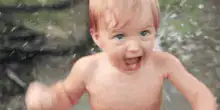 Excited baby in the rain