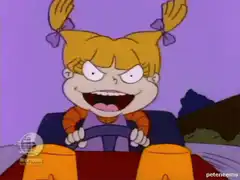 Angelica driving with evil grin