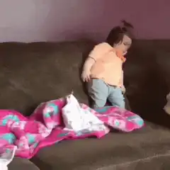 Toddler dancing on couch