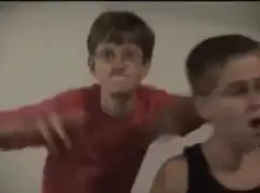 Boy in red shirt dancing and waving arms